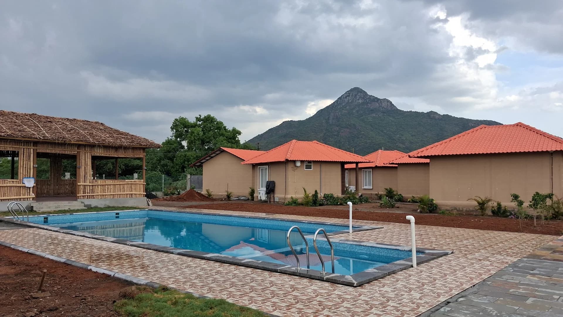 Outdoor Swimming Pool at Anaasa Shivoham Tiruvannamalai with Arunachala Hill view